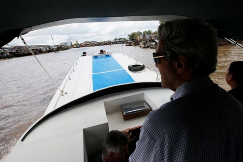 Dressed in casual khaki-green trousers, a blue-checked shirt and wearing sunglasses, Kerry is surrounded by aides and other officials on the boat but he is mostly quiet and introspective.   Read more: http://www.smh.com.au/environment/climate-change/john-kerry-warns-of-climate-risks-in-return-to-mekong-delta-20131216-2zfvn.html#ixzz2ndHCPgyc