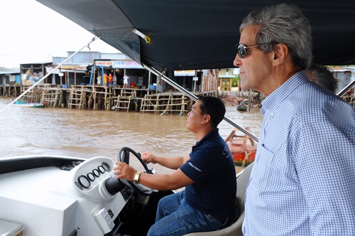 While the ringing of cell phones may have replaced the thunder of artillery fire, back on the boat Kerry looked out at the jungle canopy that rises just off the riverbank, swept his arm and remarked: