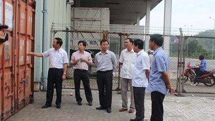 Phó Chủ tịch UBND tỉnh Quảng Ninh Đặng Huy Hậu (ngoài cùng bên trái) tại hiện trường lưu giữ hai container chứa dầu biến thế nhiễm PCB tại cảng Cái Lân.  Ảnh: Đỗ Hoàng