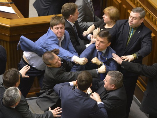 Communist lawmakers scuffle with right-wing Svoboda ( Freedom) Party lawmakers during a parliament session of Verkhovna Rada, the Ukrainian parliament, in Kiev, Ukraine Tuesday, April 8, 2014