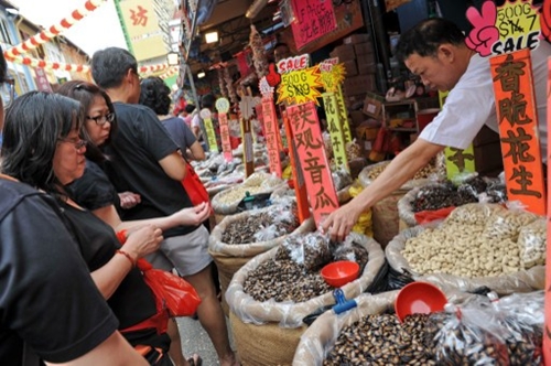 People buy sunflower seeds ahead of the Lunar New Year in Singapore on January 24, 2014. Ethnic Chinese will be celebrating the Lunar New Year of the Horse on January 31