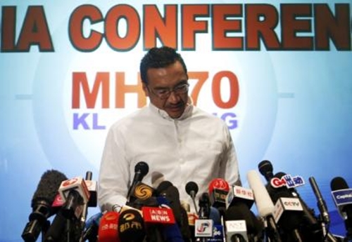 Malaysias acting Transport Minister Hishammuddin Hussein reads a statement during a news conference about the missing Malaysia Airlines flight MH370, at Kuala Lumpur International Airport