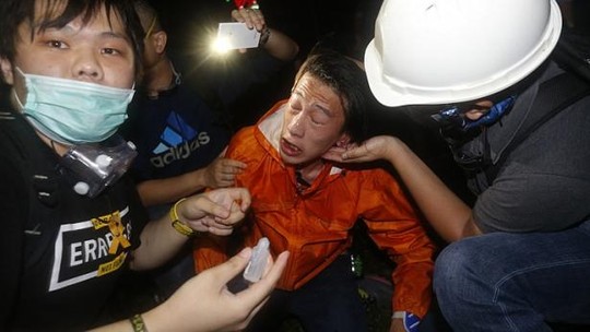 A pro-democracy protester is treated after police used pepper spray during a rally close to the government headquarters in Hong Kong, on Nov 30, 2014. -- PHOTO: REUTERS 