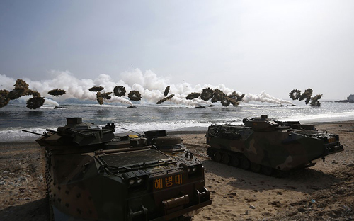 [Caption]South Korean marine LVT-7 landing craft fired multiple smoke bombs over the landing site, making rings of olive green smoke that would obscure their activitiesPicture: AP