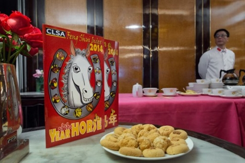 A waiter stands by a buffet during an event for the release of the annual CLSA Asia-Pacific Markets feng shui index of the upcoming Chinese New Year of the horse, in Hong Kong on January 22, 2014. The report is based on the signs of the Chinese zodiac and features lighthearted predictions for financial markets, property and celebrities