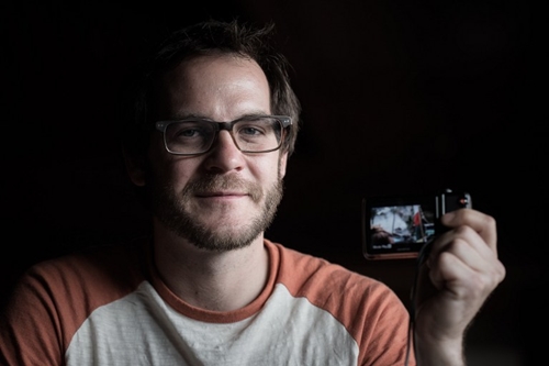 In this photograph taken on May 3, 2015, US trekker Corey Ascolani, 34, holds the camera he used record a video of the earthquake during an interview in Kathmandu. Ascolani was among hundreds of tourists travelling in the scenic Langtang region when a 7.8-magnitude earthquake on April 25 flattened villages and unleashed avalanches in Nepals Himalayas, killing more than 7,300 people. AFP PHOTO/Philippe Lopez