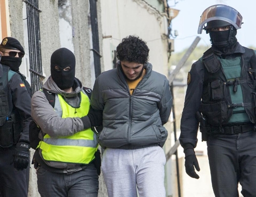 One of four people suspected of using Internet platforms to recruit young women to join the Islamic State group is arrested in the Spanish enclave Melilla on February 25, 2015 (AFP Photo/Angela Rios)