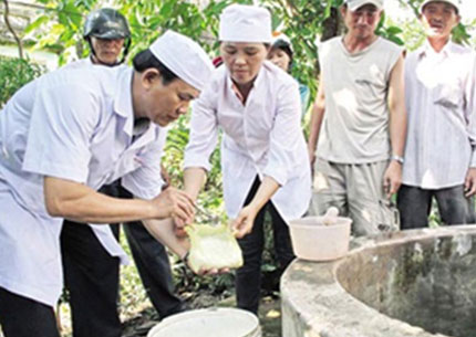 Cán bộ y tế hướng dẫn người dân cách khử khuẩn nguồn nước, đảm bảo nước sinh hoạt sạch trong mưa lũ Ảnh Internet