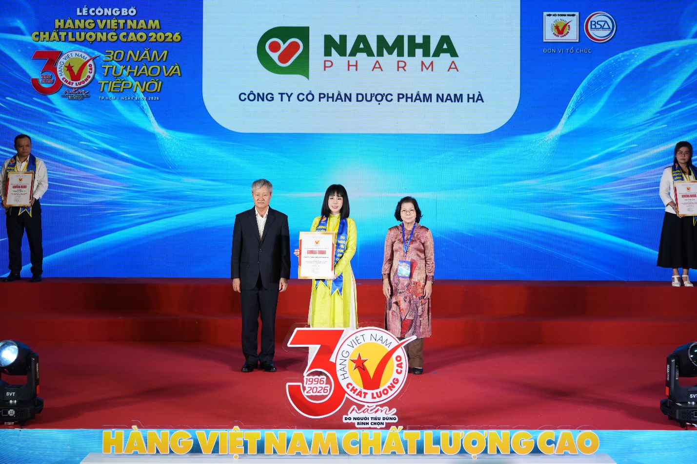 A group of people standing on a stage  Description automatically generated