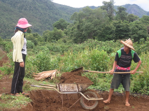 Một cặp vợ chồng Lào Việt mới kết hôn cùng nhau lấy đất đổ nền cho ngôi nhà mới.