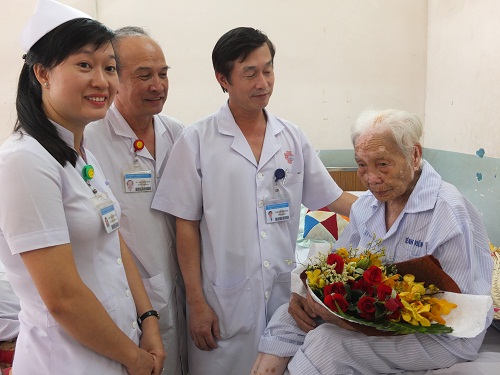Các bác sĩ chúc mừng Mẹ Việt Nam Anh Hùng N.T.P trước khi xuất viện