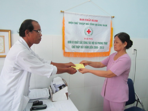 BS. Trần Phước Ta - Chủ tịch Hội Chữ thập đỏ bệnh viện trao quà cho bệnh nhân nghèo.