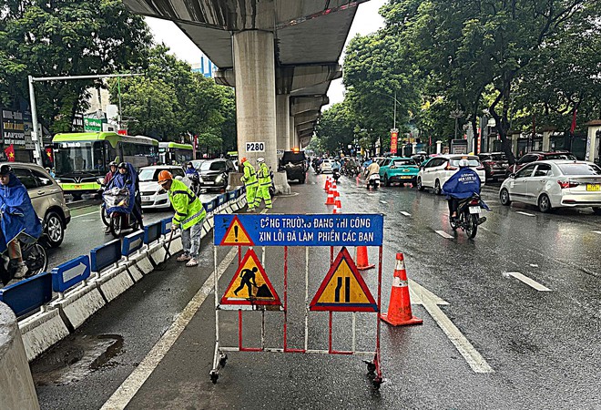Công nhân 'đội mưa' dọn dẹp đường phố Hà Nội trước kỳ nghỉ Lễ Quốc khánh 2/9- Ảnh 3.