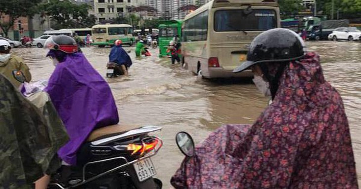 Mưa lớn kéo dài cả đêm, người dân Hà Nội đi làm trong "biển nước"
