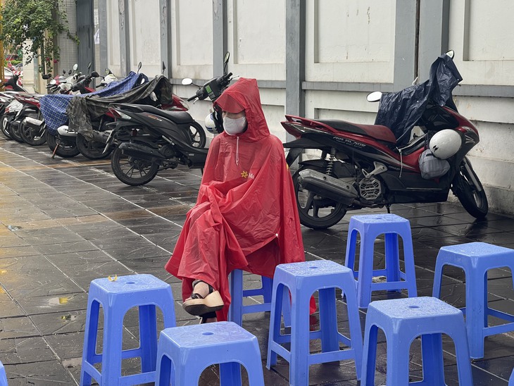 Phụ huynh lặng lẽ "dầm mưa" ngồi đợi con thi tốt nghiệp THPT - Ảnh 7. Phụ huynh lặng lẽ "dầm mưa" ngồi đợi con thi tốt nghiệp THPT - Ảnh 7.