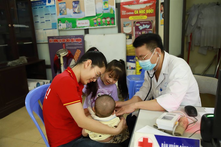 A doctor examining a baby with a child  AI-generated content may be incorrect.