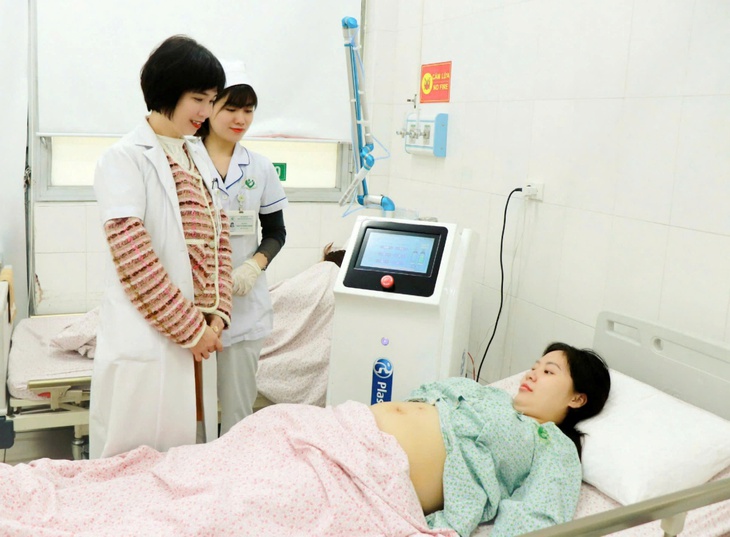 A person lying in a hospital bed with a doctor standing next to her  AI-generated content may be incorrect.