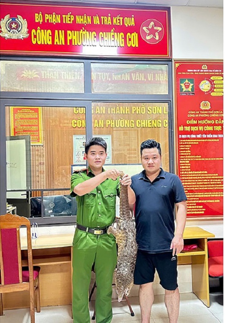 Đang đi taxi thấy tê tê bò trên đường, người dân bắt giao nộp cho Công an - Ảnh 1.