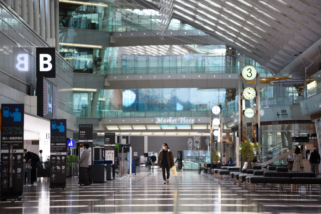 A man walks through the departures lobby at Haneda Airport in Tokyo, Japan, on April 23, 2020.