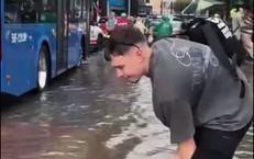 Mưa ngập đường, khách Tây hào hứng lội nước giữa trung tâm TPHCM