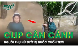 Cận cảnh khoảnh khắc người dân ném dây thừng cứu người phụ nữ bị nước cuốn trôi cùng xe máy