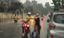Khoảnh khắc đẹp nhất ngày mưa: Cô gái Hà Nội dừng xe, mặc áo mưa cho cụ bà trong cơn dông