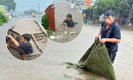 Nước ngập gần 1m, trưởng thôn ngụp xuống cống vớt rác giữa mưa lớn