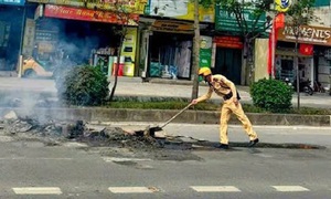 CSGT dọn dẹp đống phế liệu cháy âm ỉ giữa đường