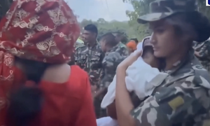 Nghẹn lòng khoảnh khắc nhân viên cứu hộ Nepal ru ngủ 2 em bé sinh đôi